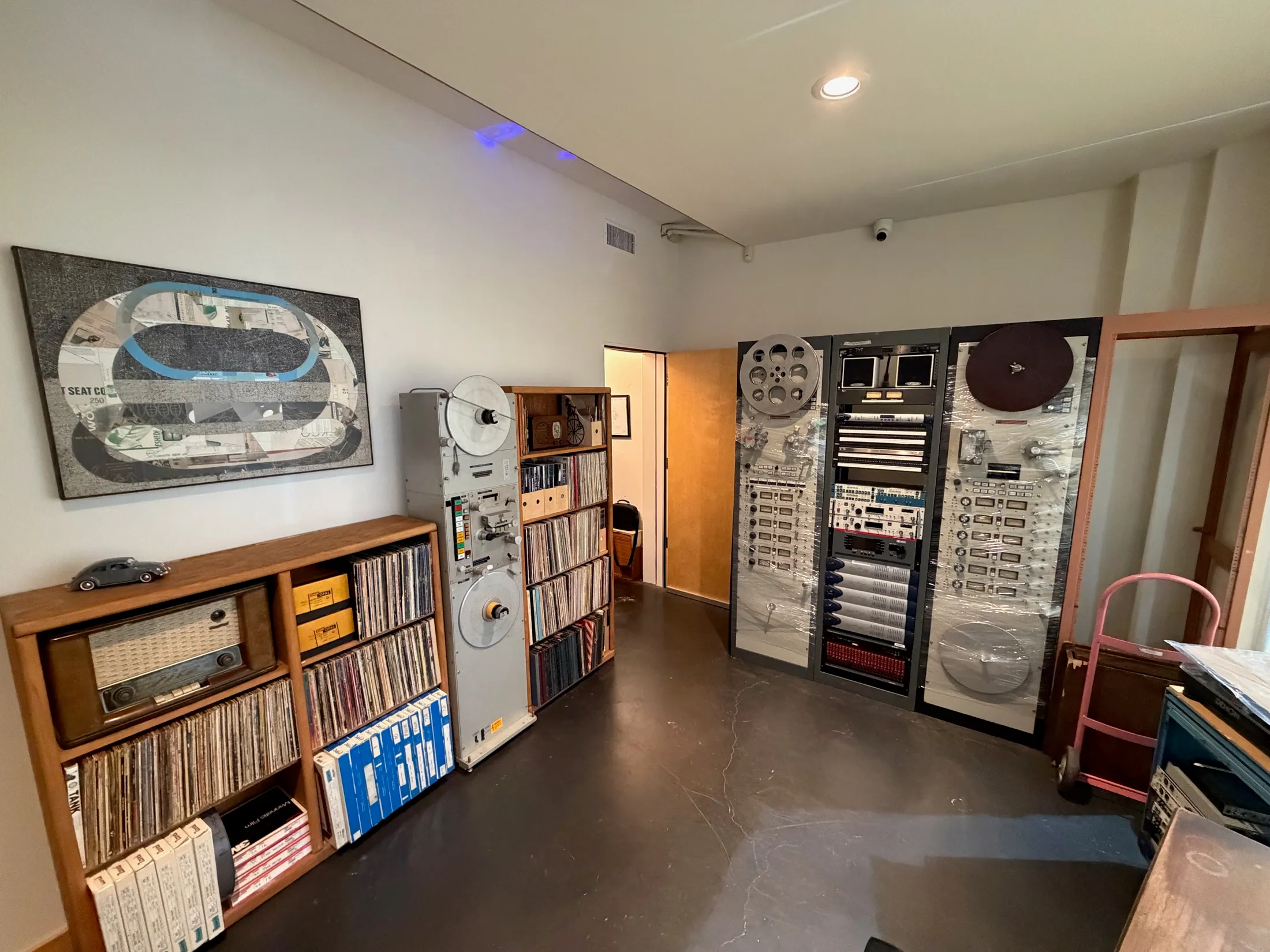 Archive room with reel-to-reel decks, vinyl, and vintage broadcast gear